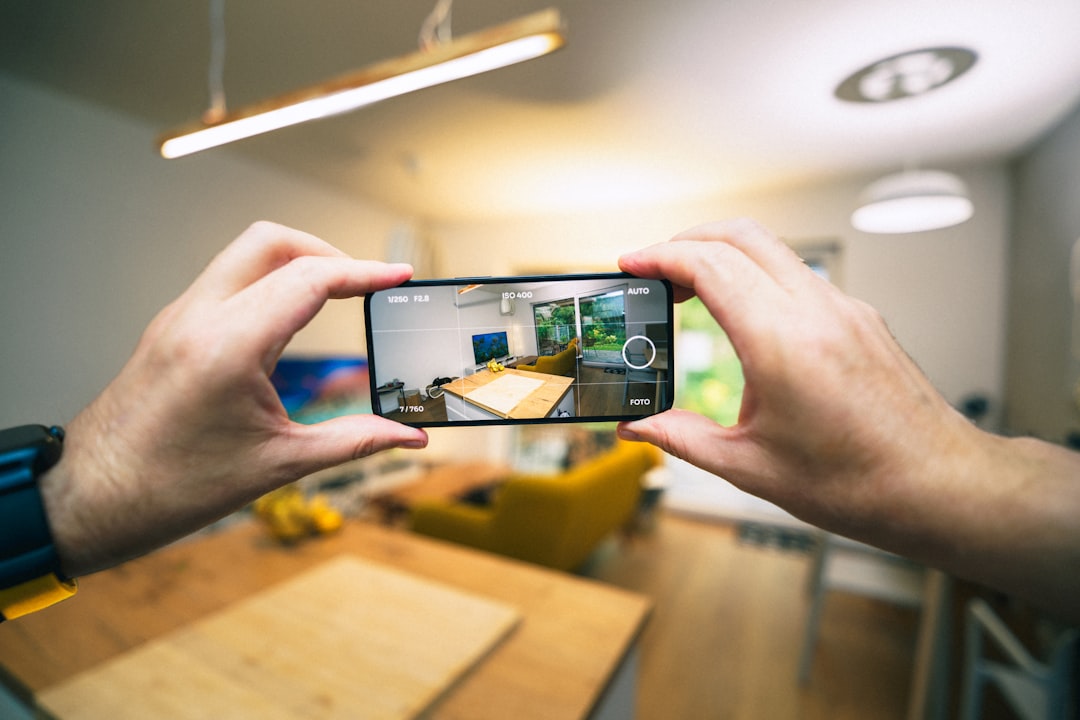 services-03 Virtual tour. Hands holding smartphone taking pictures for selling apartment.